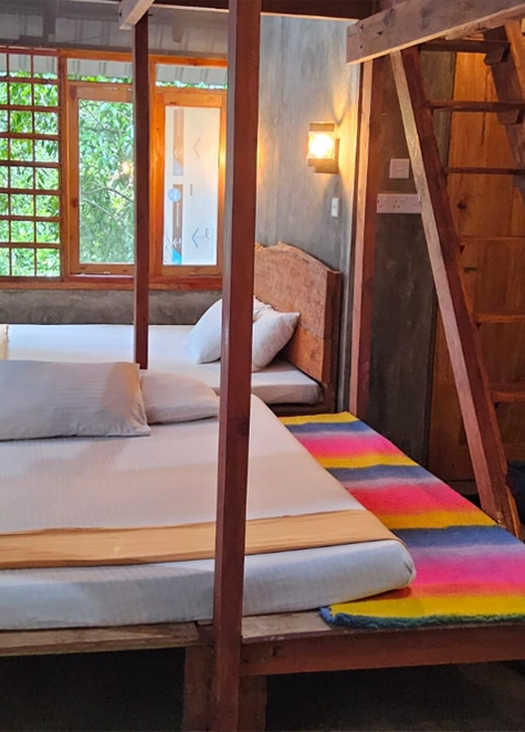 Timber cabana interior with beds open to the canopy